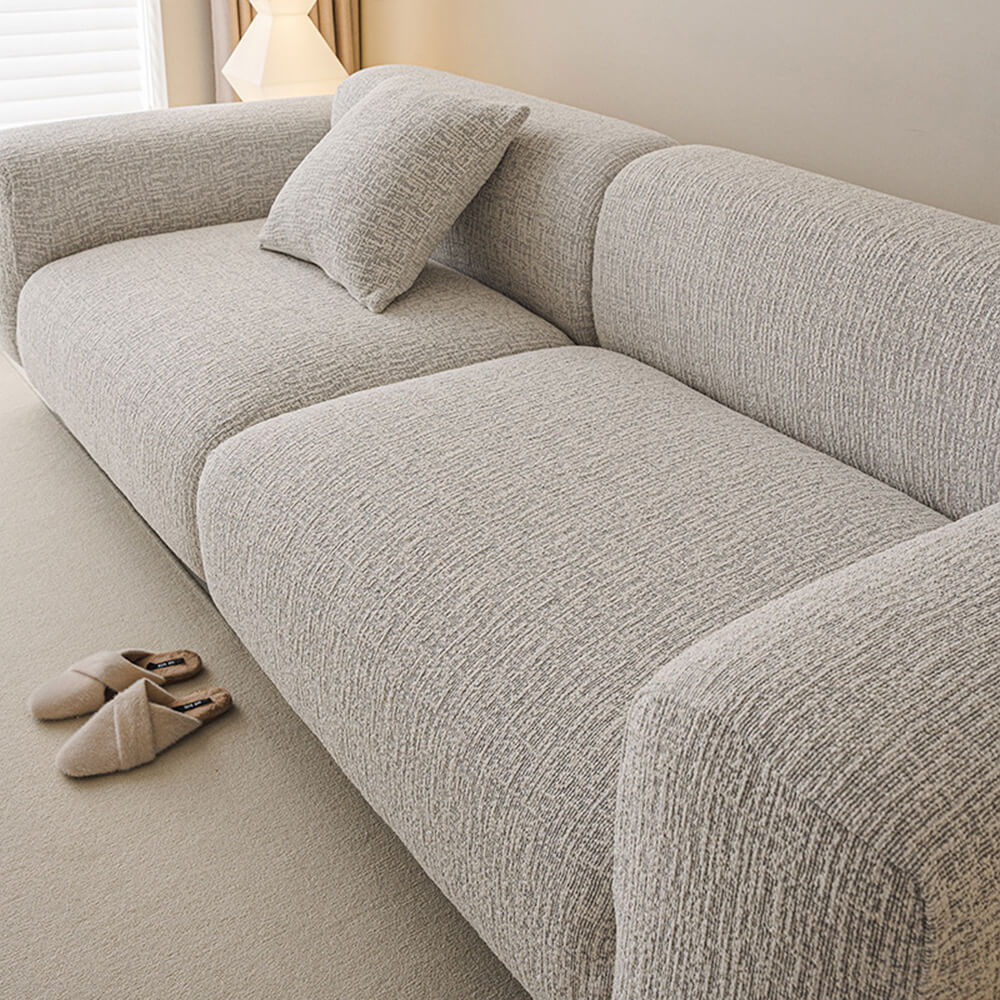 Full view of a living room with elegant chenille stretch sofa cover protecting a couch