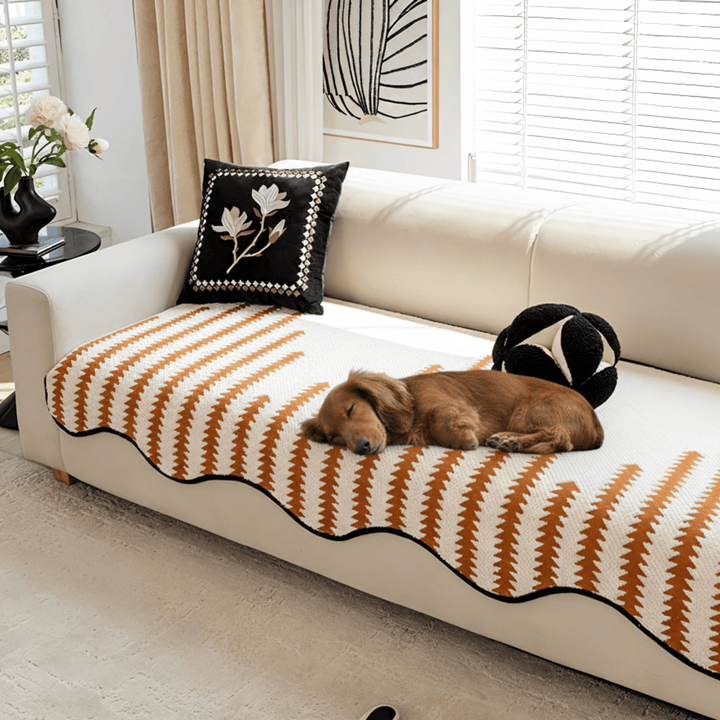 Full view of a living room sofa with a chic chevron chenille furniture protector