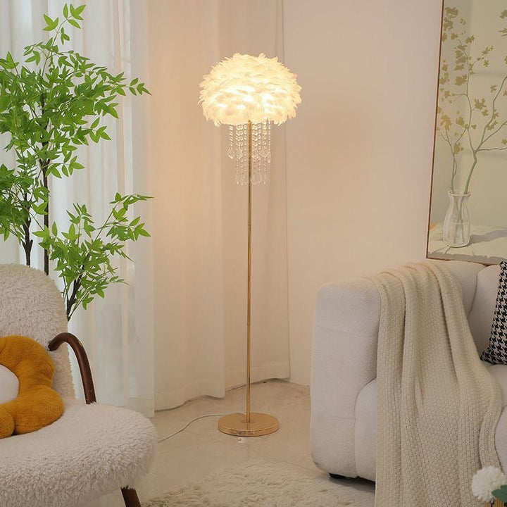 Close-up of delicate white feathers & sparkling crystals on the modern floor lamp.