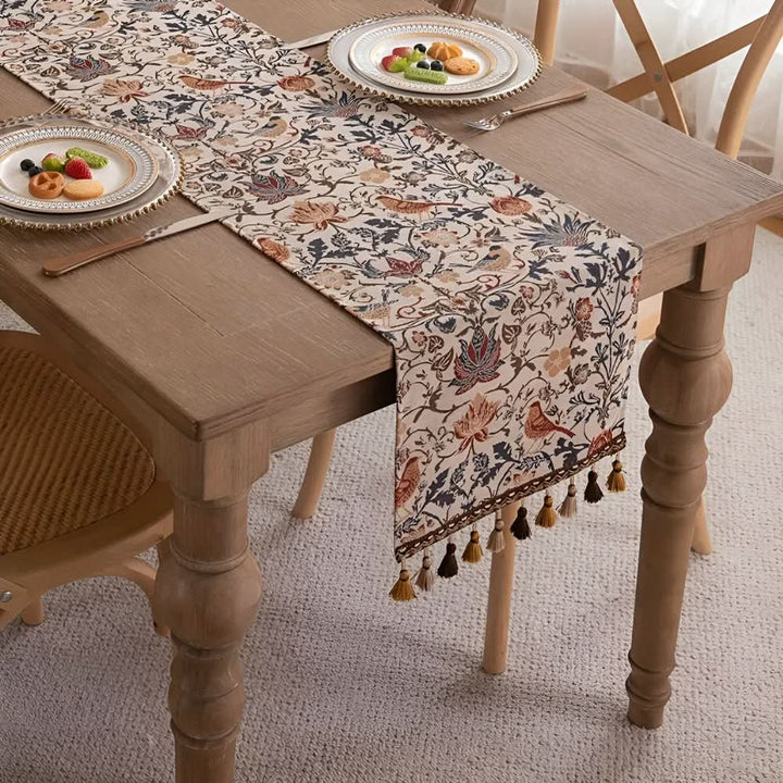 Rustic charm fringed jacquard table runner featuring elegant floral & bird design.