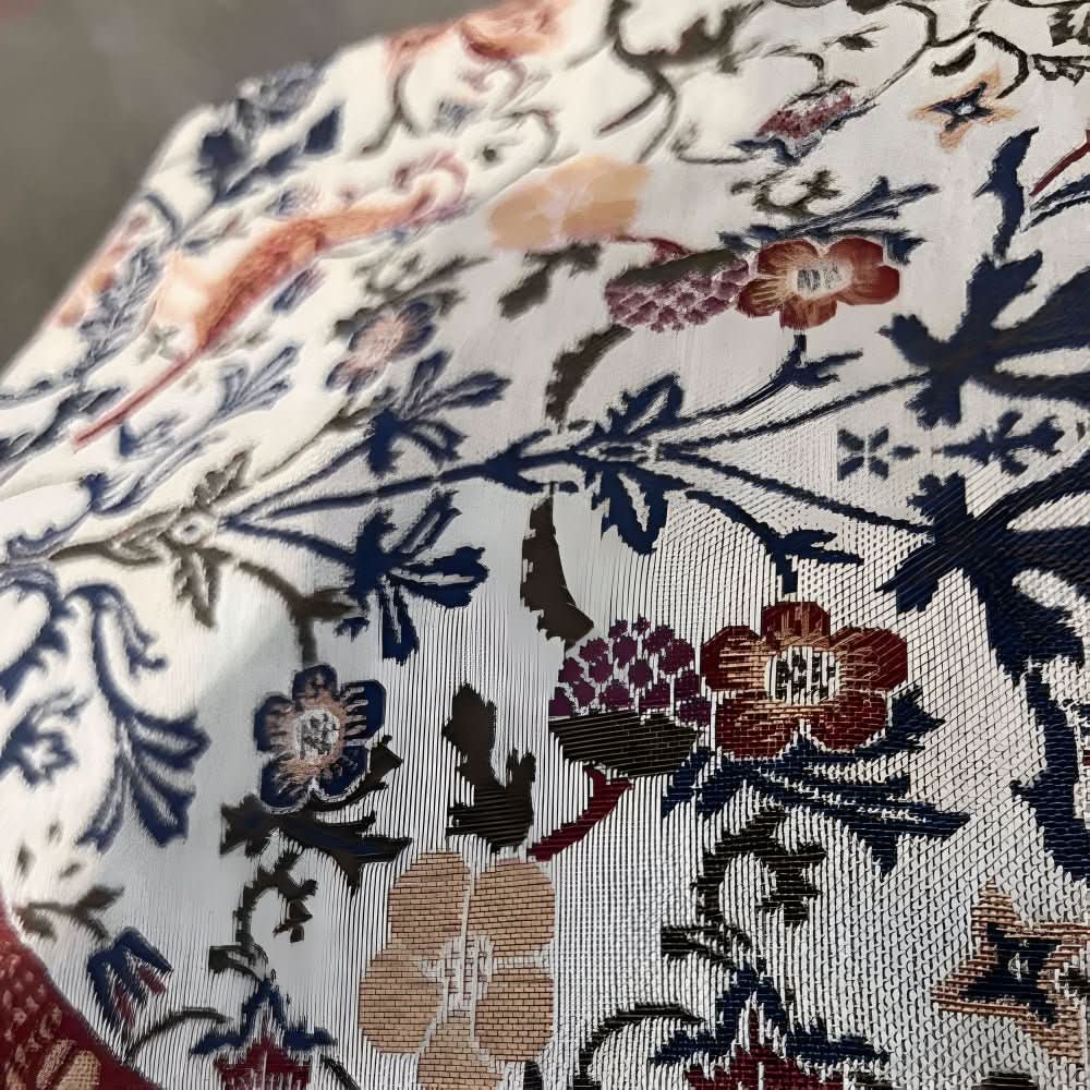 Elegant fringed table runner: Jacquard weave, featuring sophisticated floral & bird patterns for tables.
