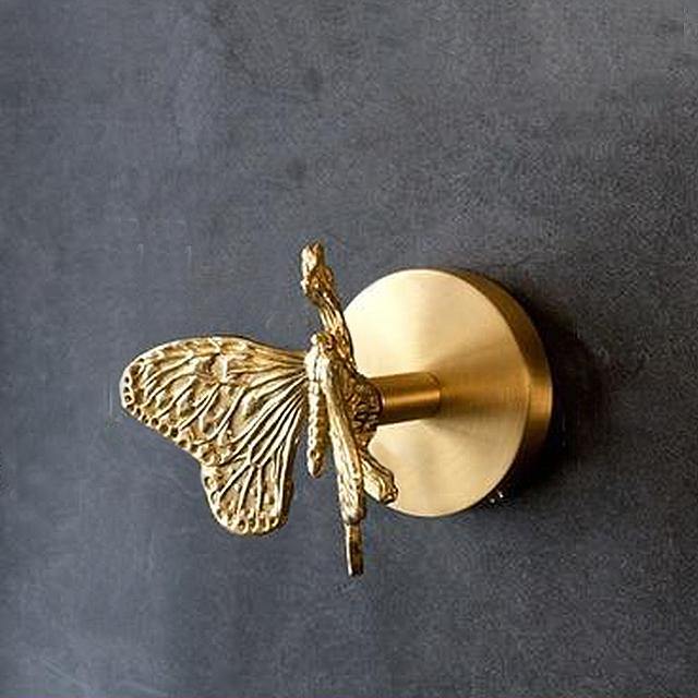 Artistic gold finish animal wall hooks, blending wall art with practical home organization.