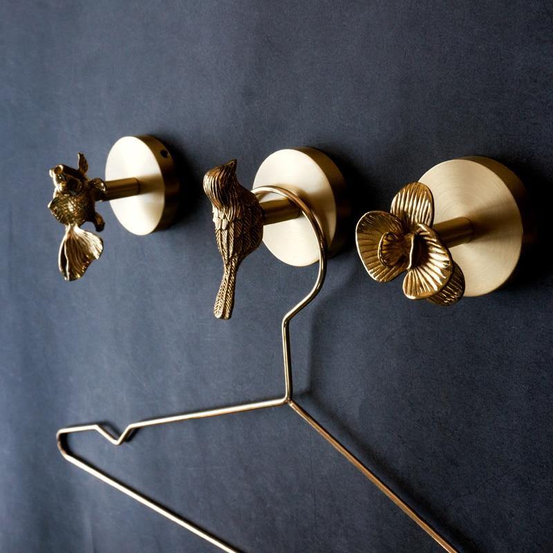 Unique gold animal wall hooks, adding elegant design to your home decor.