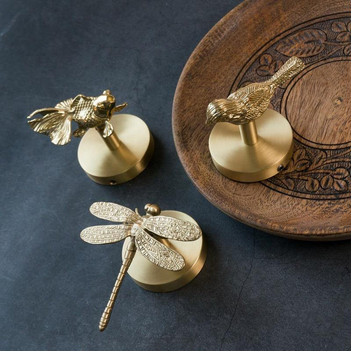 Decorative gold animal wall hooks, ideal as a stylish entryway organizer.