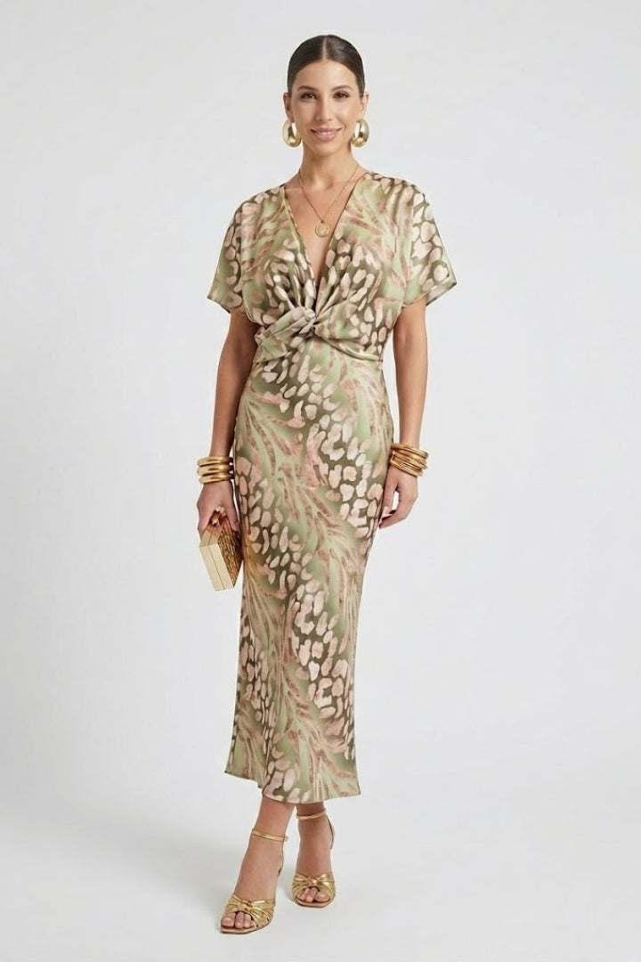 Women's green floral V-neck midi dress featuring a stylish pleated hem and short sleeves, perfect for summer.