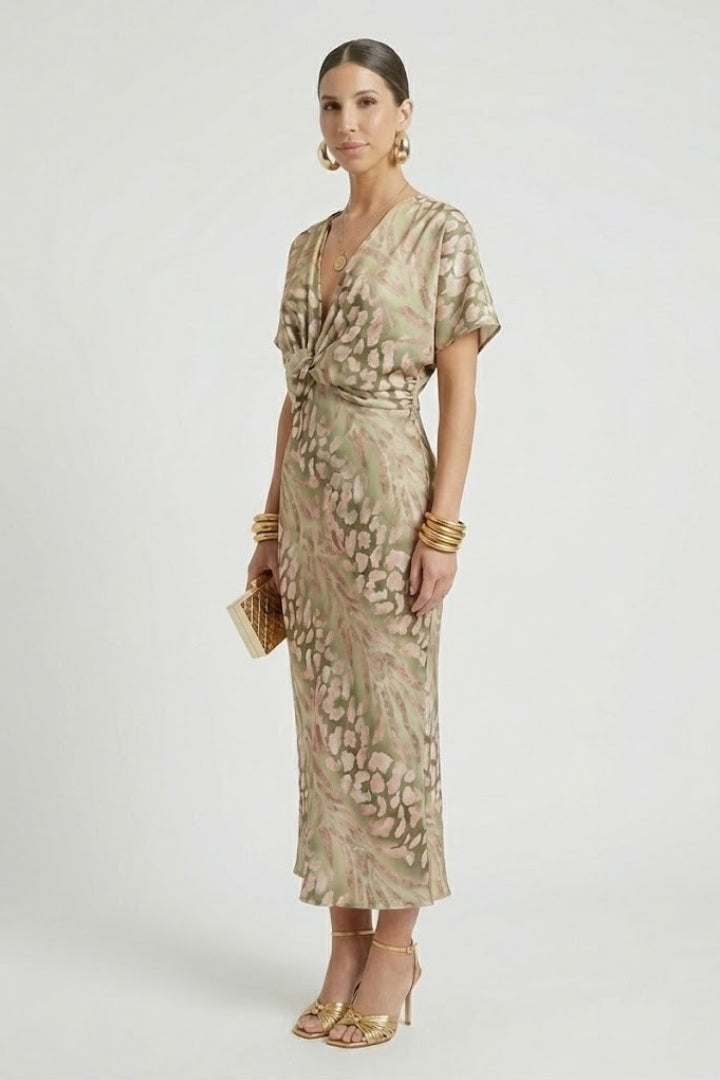 Fashionable women's green floral midi dress with a flowy pleated hem. Elegant V-neck, short sleeves for warm weather.