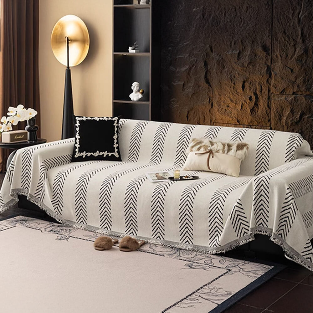 Sophisticated herringbone pattern on a soft chenille throw, perfect for modern and classic interiors.