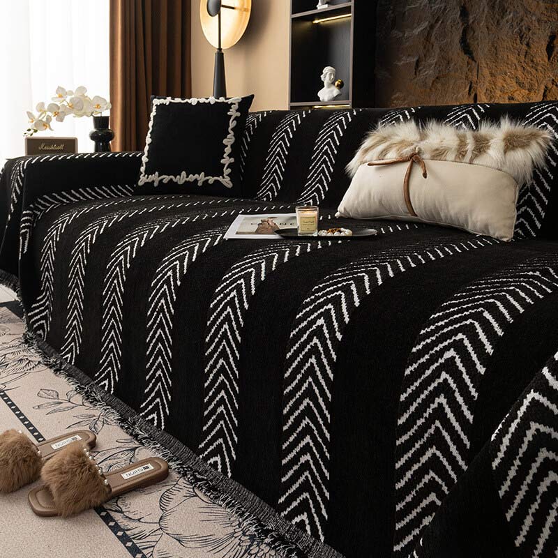 Pet-friendly herringbone chenille cover safeguarding a couch while adding a decorative touch.