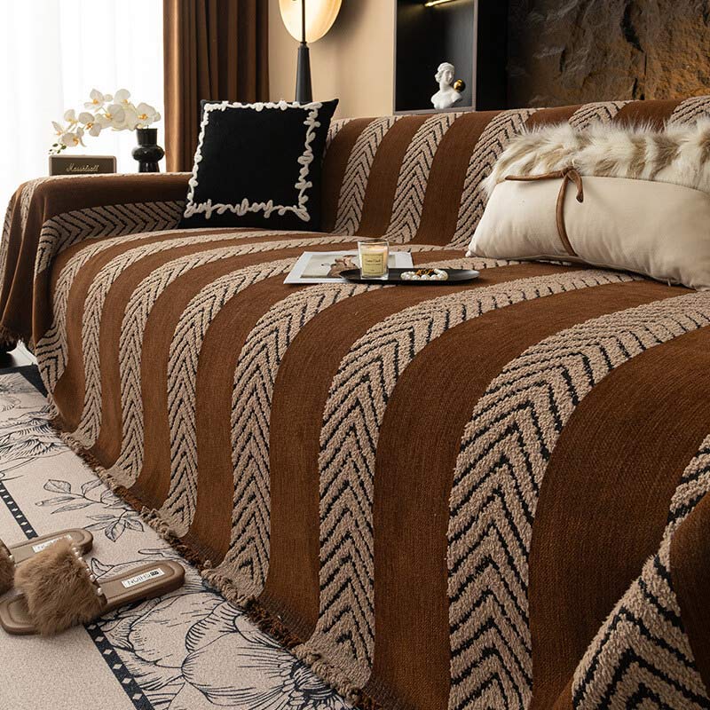 Versatile herringbone chenille throw, serving as a sofa cover, decorative accent, and furniture protector.