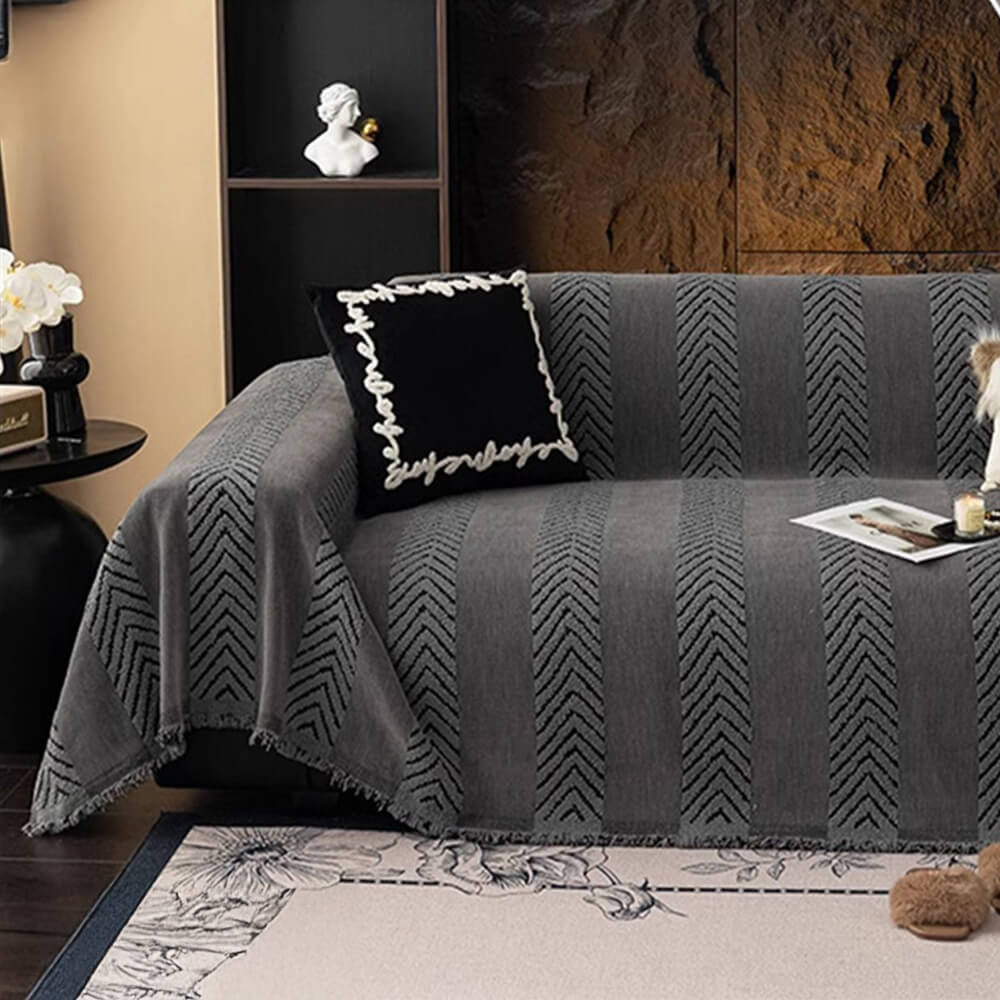 Luxury herringbone chenille throw draped over a couch, a stylish and practical furniture protector.