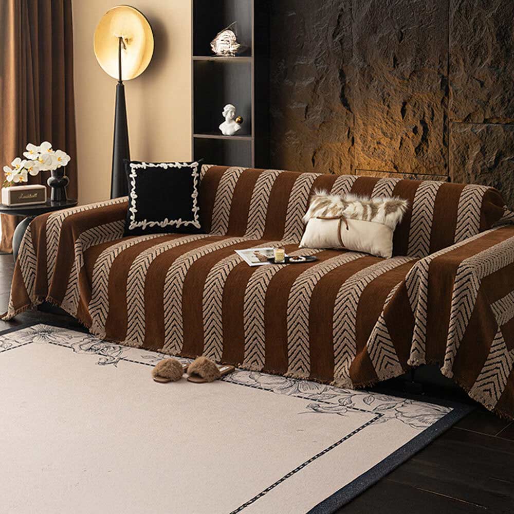 Full view of a living room sofa covered with a plush herringbone chenille throw, looking inviting.