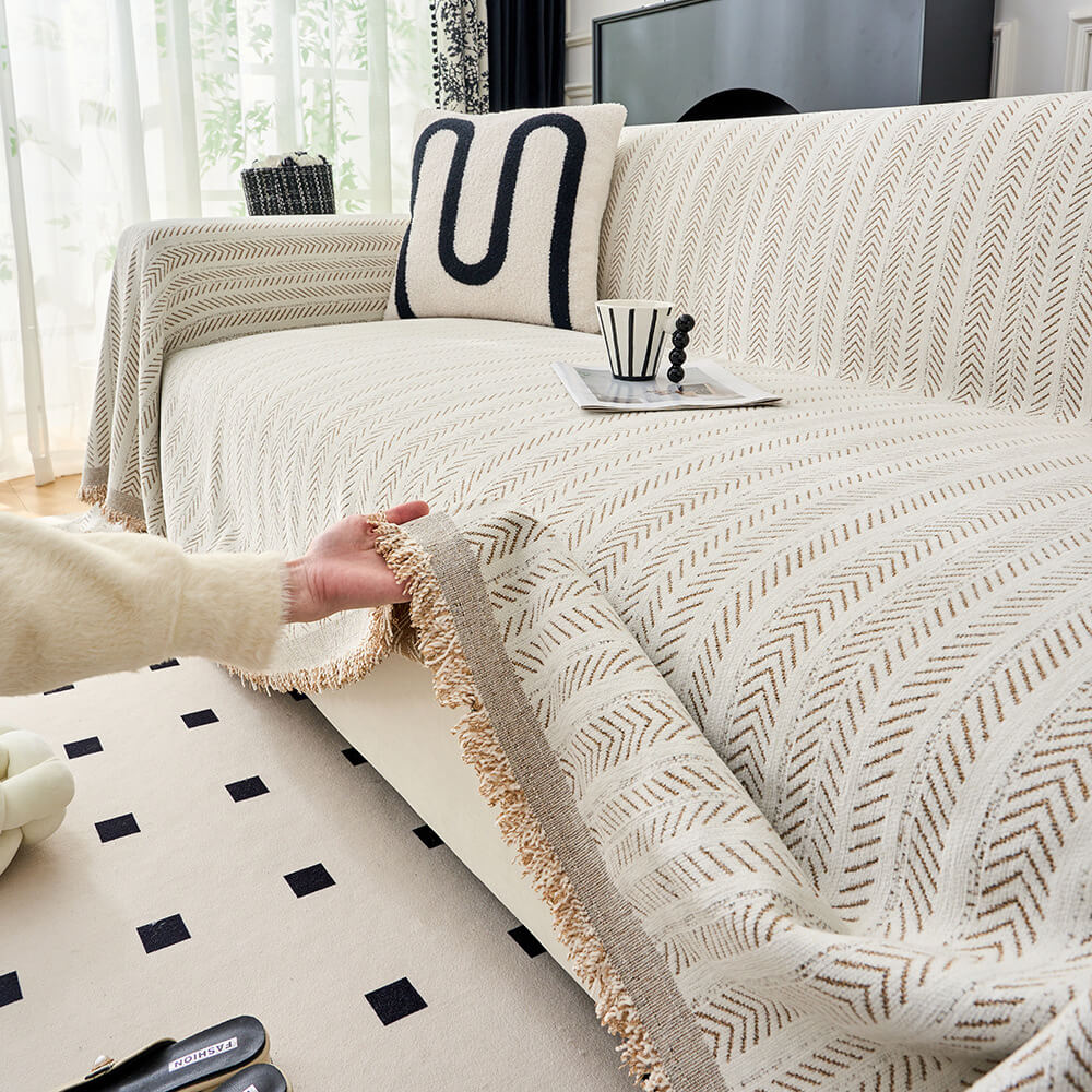 Elegant herringbone chenille throw cover draped over a sofa, showcasing soft texture & home decor style