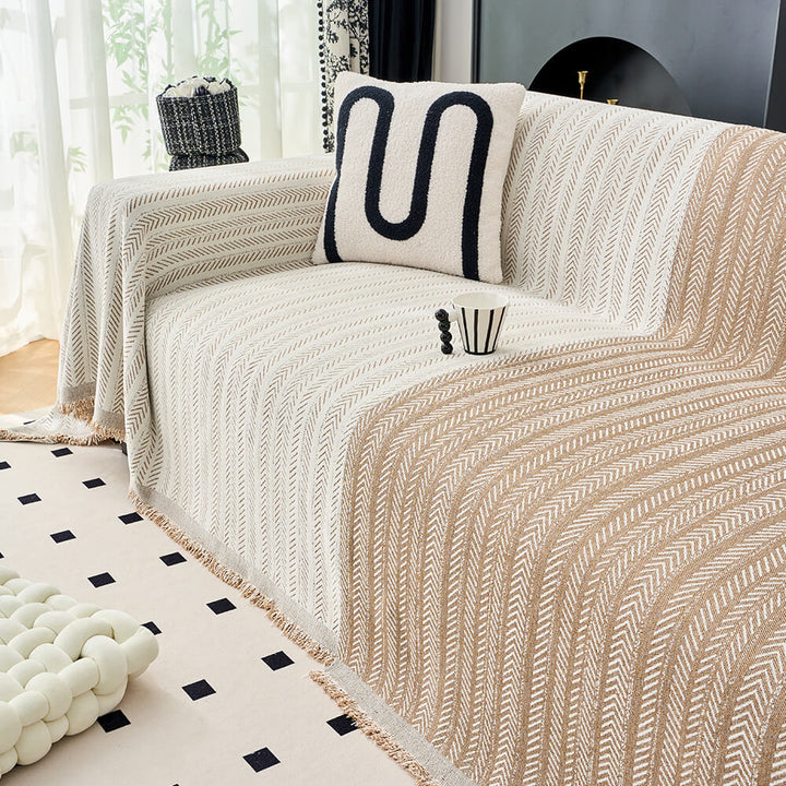 Detail of the soft texture and herringbone pattern of a chenille multi-use throw blanket