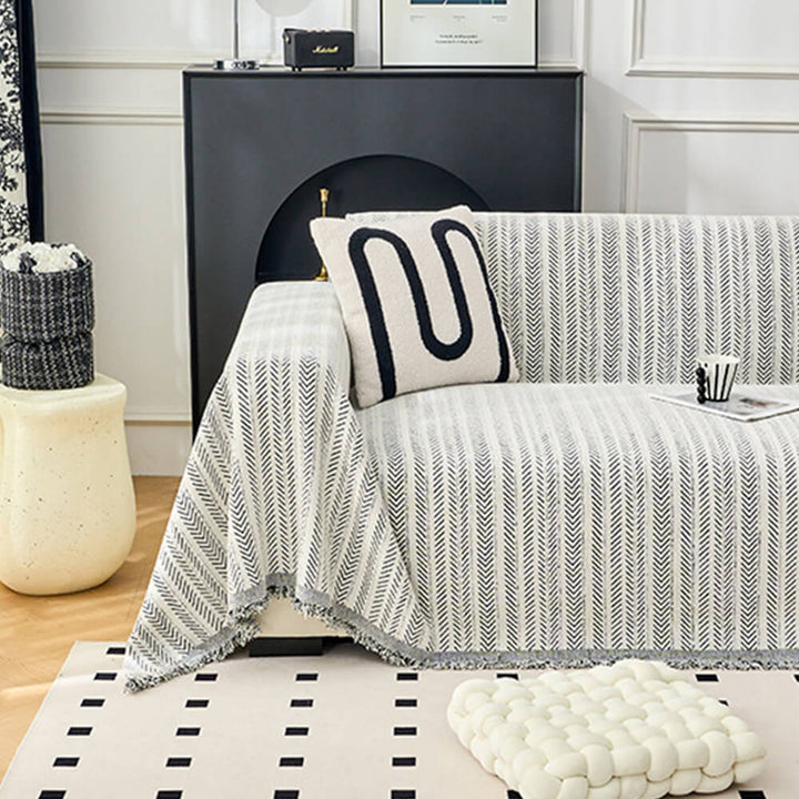 Full view of an elegant herringbone chenille couch cover, styled for a cozy home decor look