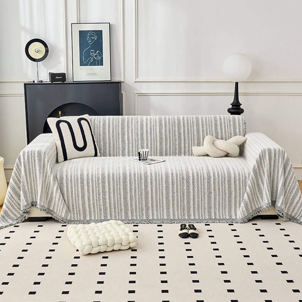 Stylish herringbone chenille throw draped over a chair, showing its versatility as a decorative accent