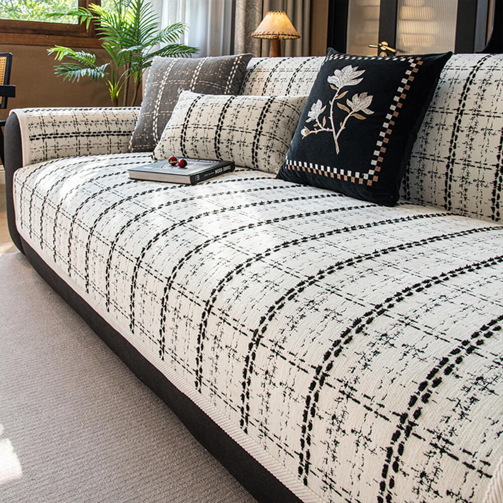 Checkered jacquard sofa protector made from soft chenille, offering all-season furniture protection.