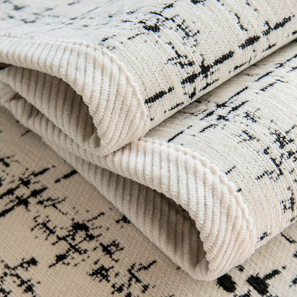 All-season sofa protector in luxurious jacquard chenille, enhancing home decor with its checkered design.
