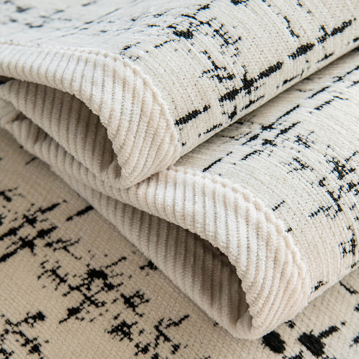 All-season sofa protector in luxurious jacquard chenille, enhancing home decor with its checkered design.