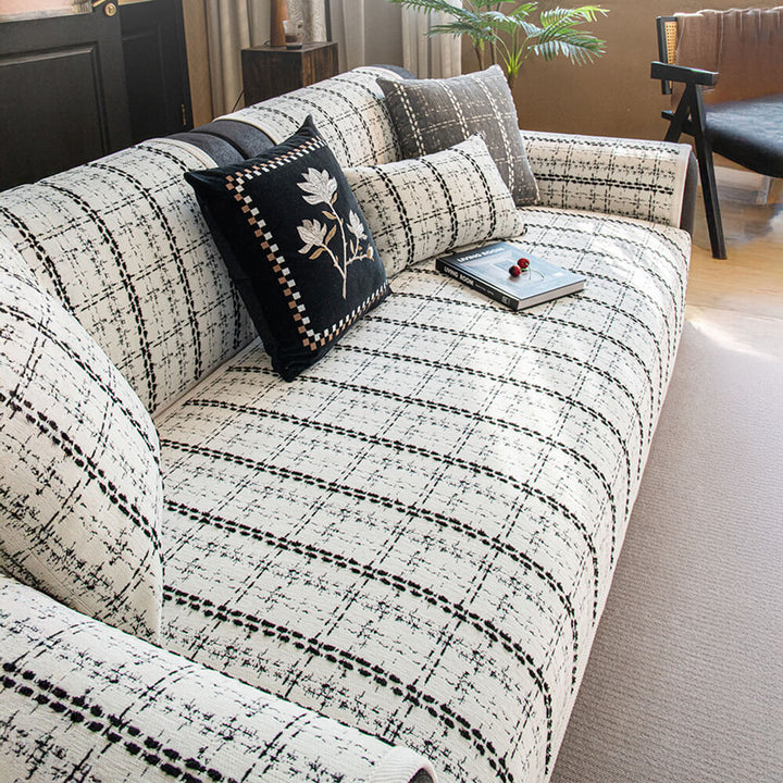 Stylish checkered jacquard sofa protector, a chenille couch cover for elegant furniture protection.