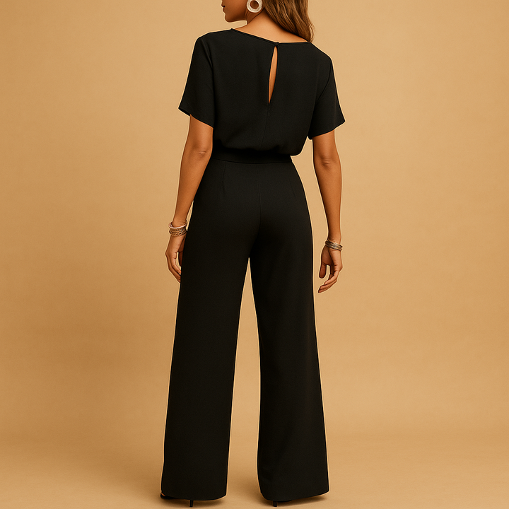 Beige women's tailored jumpsuit with flowy sleeves, a chic choice for wedding guests.