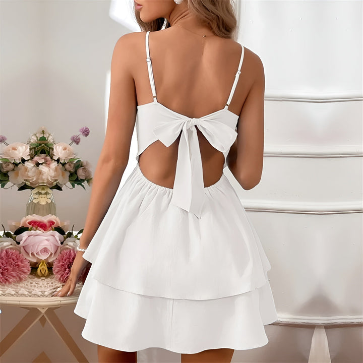 Women's dark red ruffle mini dress with thin straps, embodies playful elegance for parties.