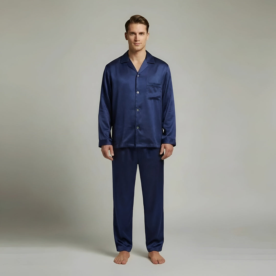 Elegant men's navy blue satin pajama set with long sleeve shirt & pants. Luxurious loungewear for comfortable relaxation.