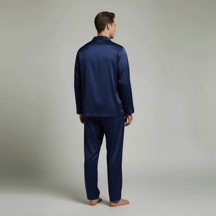 Stylish men's navy blue satin pajama outfit set. Long sleeve top & pants for elegant sleepwear or casual loungewear.