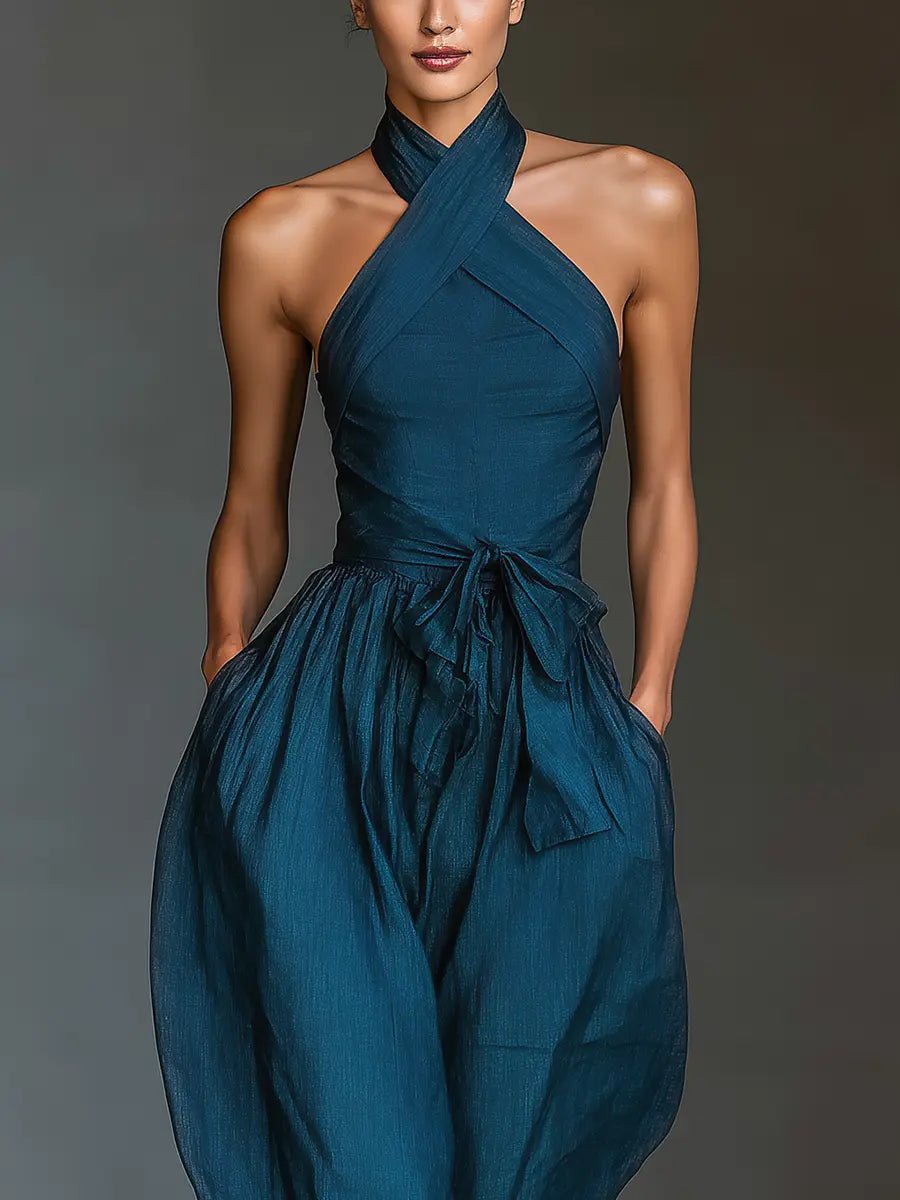 Sleeveless navy blue halter jumpsuit for women featuring a stylish wide-leg design. Elegant party outfit.