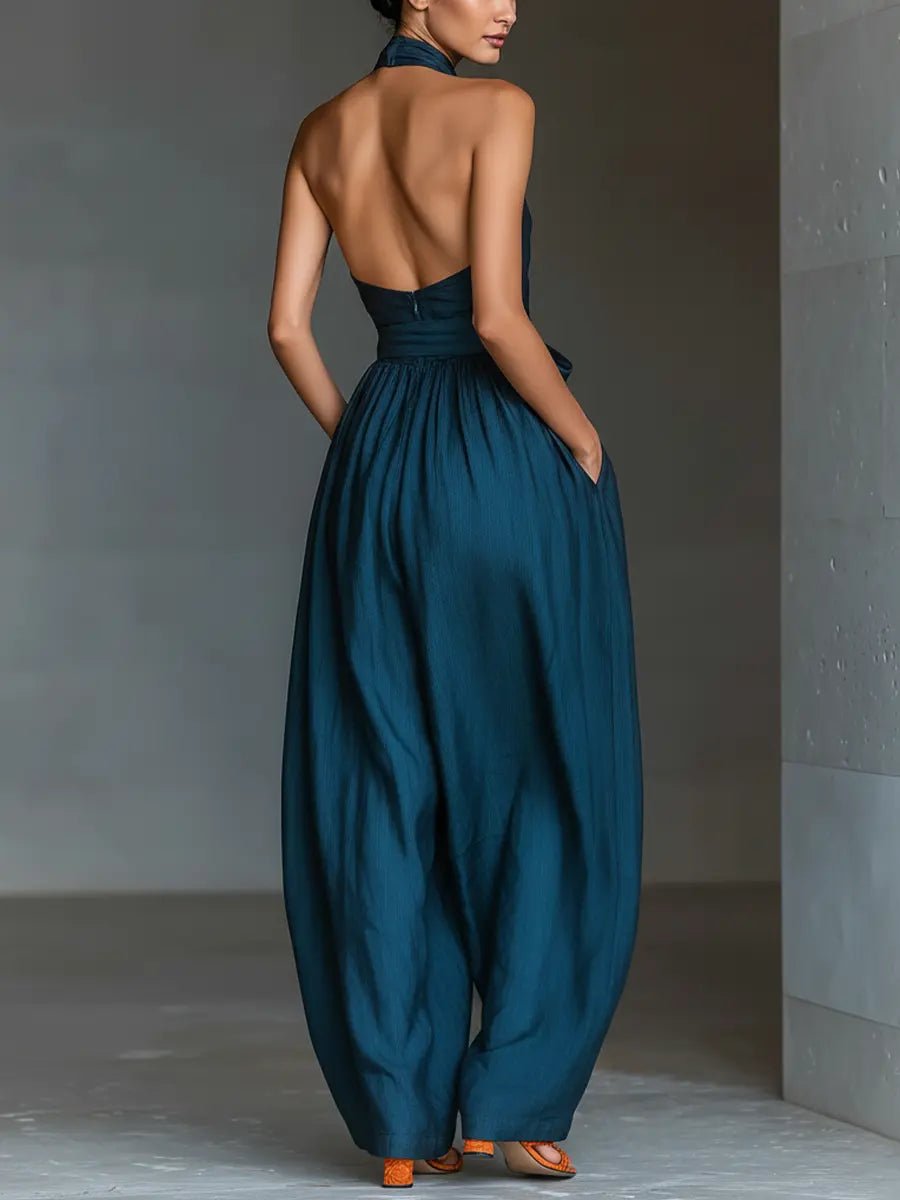 Fashionable navy blue halter wide-leg jumpsuit for women, a sophisticated one-piece for any special event.