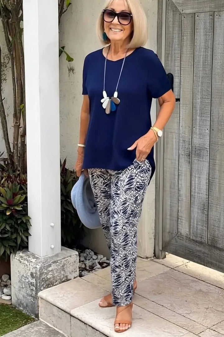Elegant navy blue patterned blouse for women, versatile for office or casual wear.
