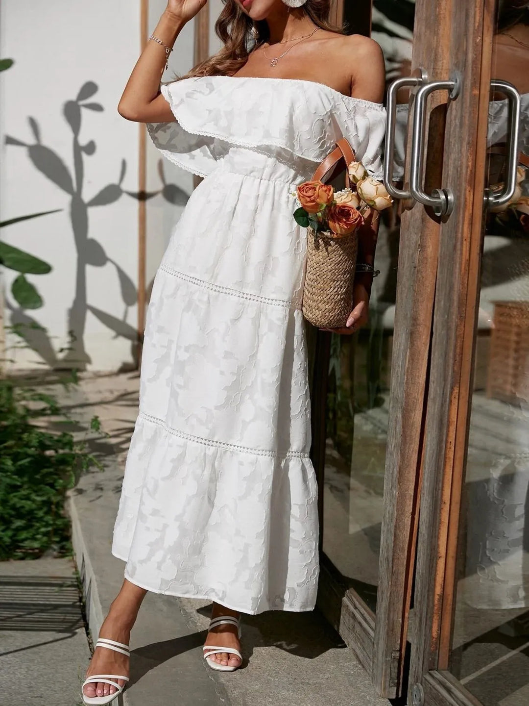 Chic off-shoulder maxi dress with elegant ruffle tiers & lace trim, a beautiful wedding guest outfit.