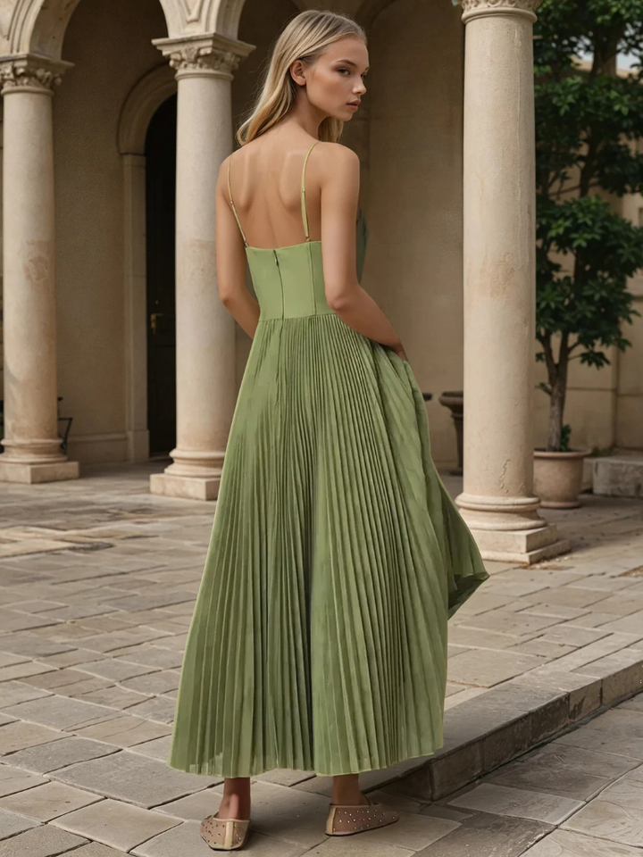 Close-up of the structured corset bodice on an olive green pleated maxi wedding guest dress. Women's elegant fashion.