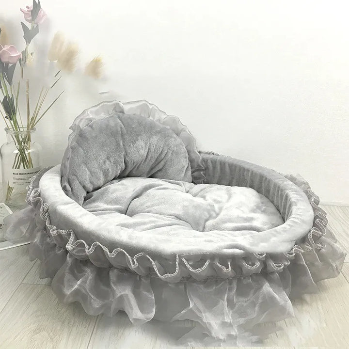 Soft pet bed in a light color, featuring a delicate tulle ruffle and a charming bow for cats.