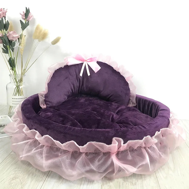 Close-up of an elegant cat bed showing the soft tulle ruffle and a perfectly tied decorative bow.