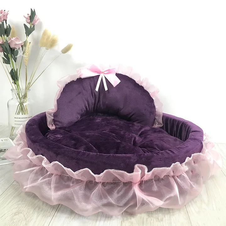 Close-up of an elegant cat bed showing the soft tulle ruffle and a perfectly tied decorative bow.