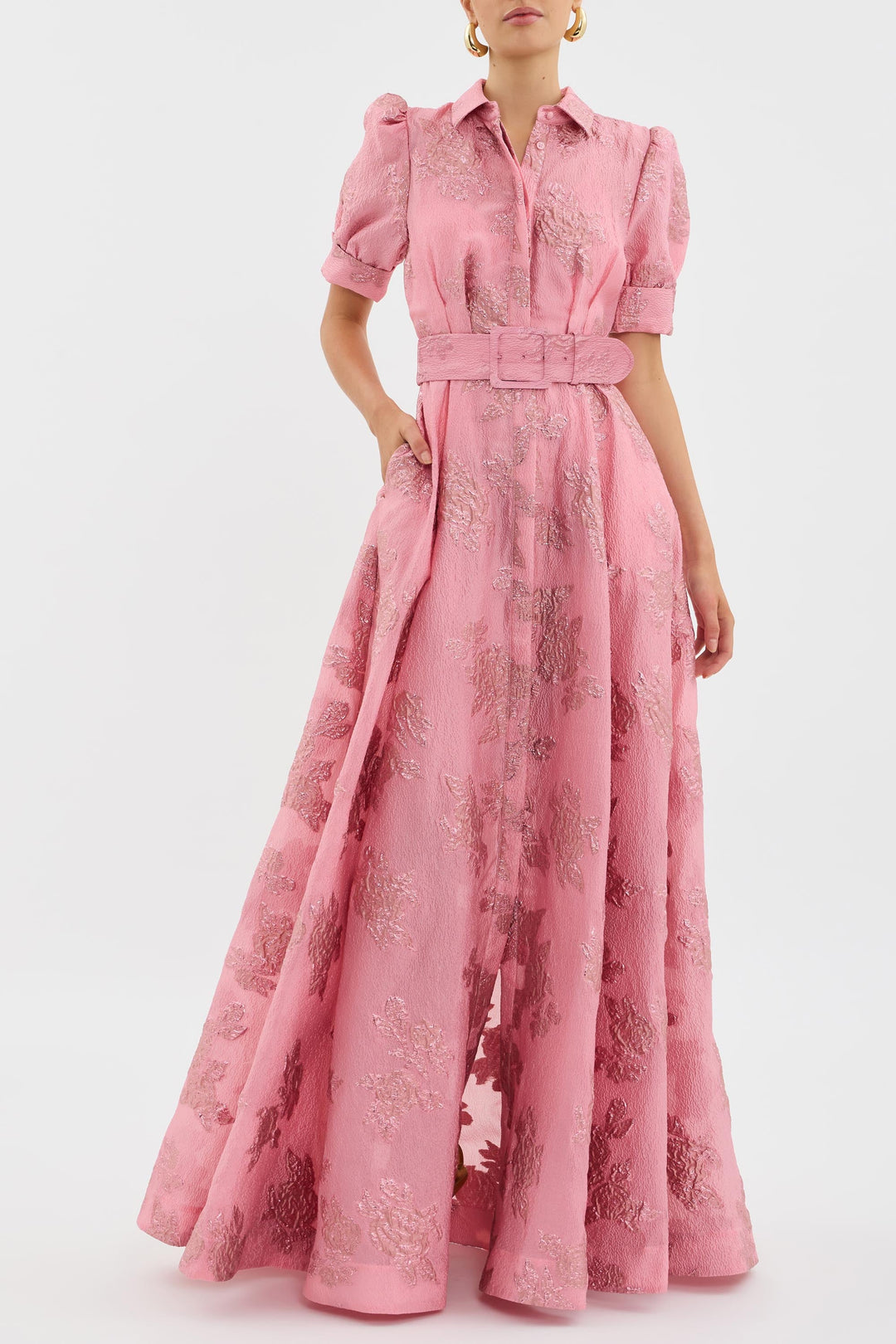 Women's elegant pink evening gown, a flowing maxi dress with belted waist, ideal for special occasions.