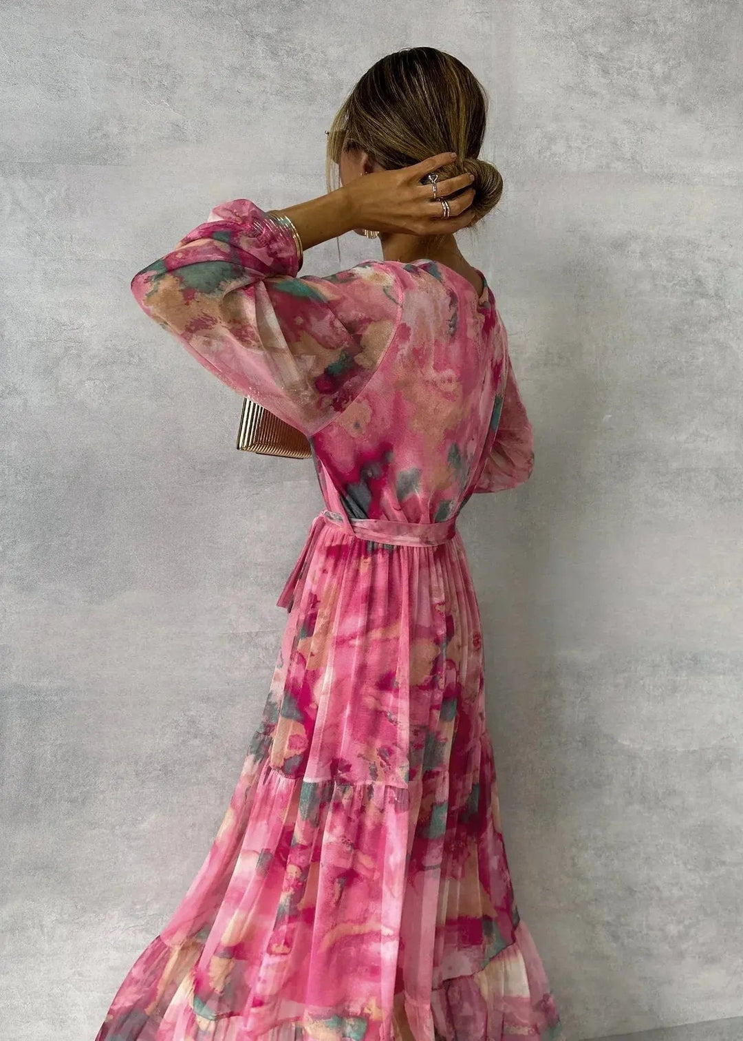 Fashionable pink women's V-neck wrap dress, a sophisticated midi length with a flattering belted waist.