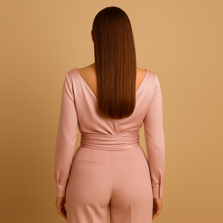Versatile women's long-sleeve pink wrap blouse with tie-waist, ideal for elegant office or comfortable everyday wear.