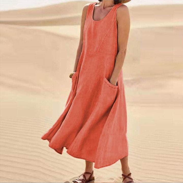 Women's elegant sleeveless dress with practical pockets, a comfortable loose-fit midi perfect for any season.