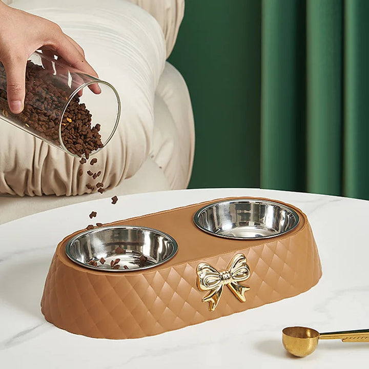 Two-bowl set of polished stainless steel pet feeders, ideal for dog and cat food or water.