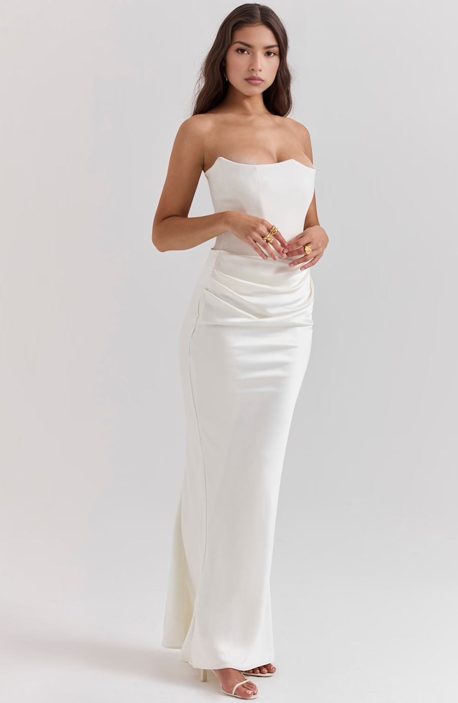 Confident woman in elegant strapless formal dress, perfect for any special occasion.
