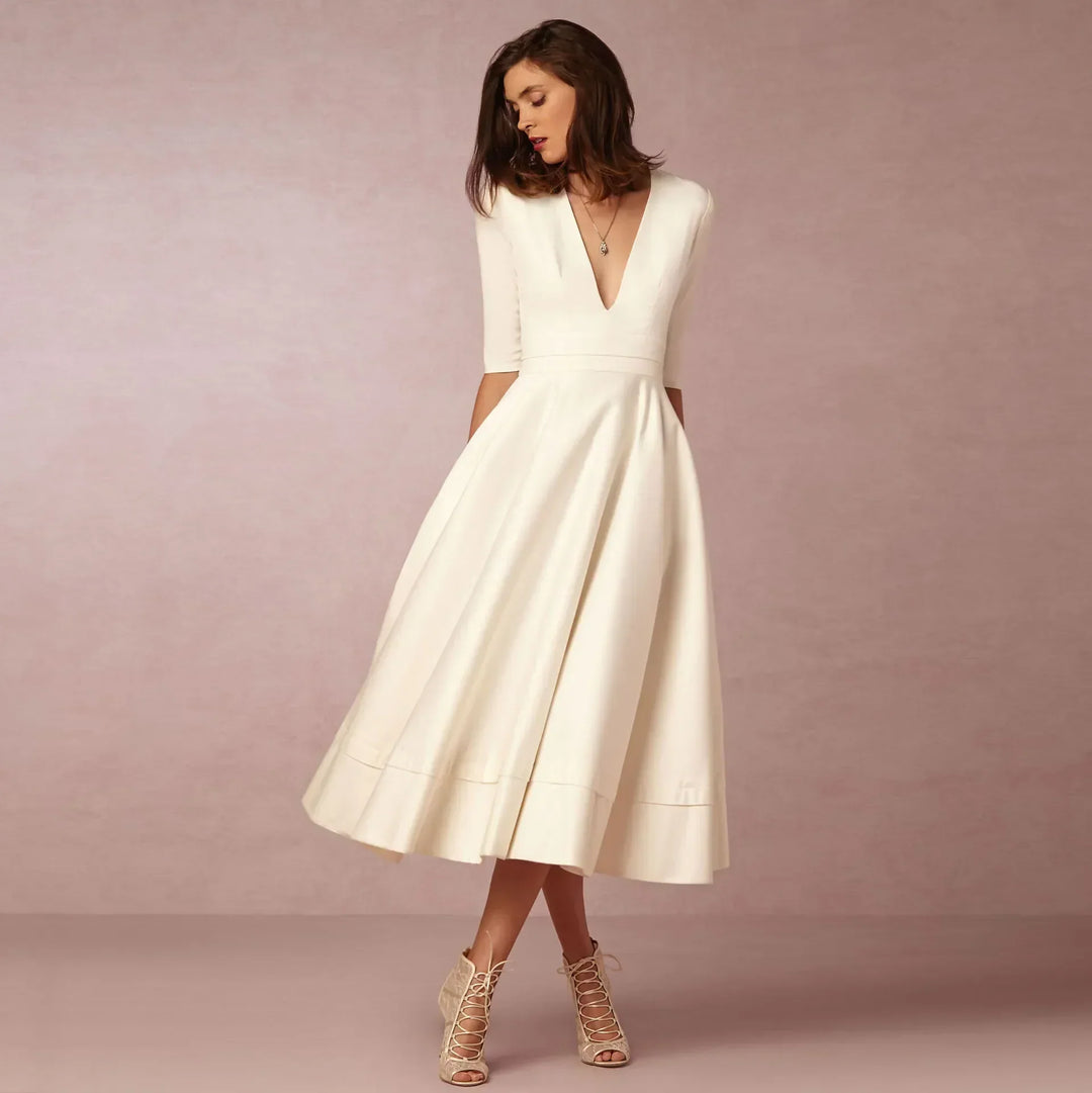 Elegant V-neck elbow-sleeve midi dress for women, perfect for sophisticated style. Day to night fashion.