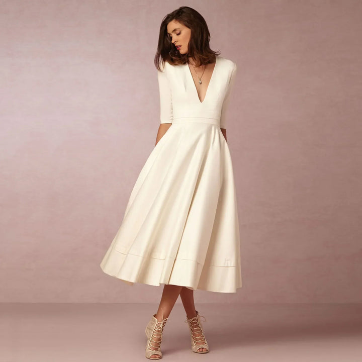 Elegant V-neck elbow-sleeve midi dress for women, perfect for sophisticated style. Day to night fashion.