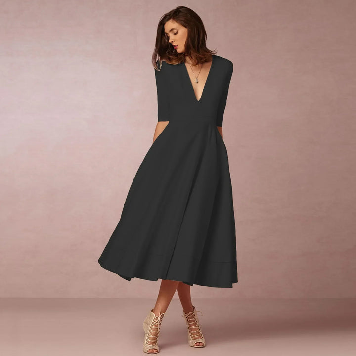 Women's elegant V-neck midi dress, featuring comfortable elbow sleeves for versatile sophisticated wear.