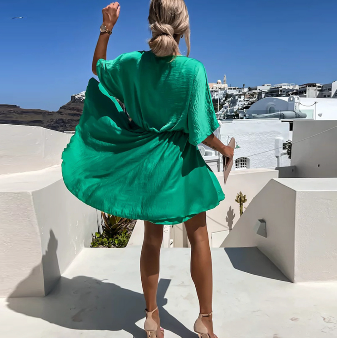 Stylish V-neck wrap mini dress for women, featuring a flowy skirt & elegant design for summer fashion.