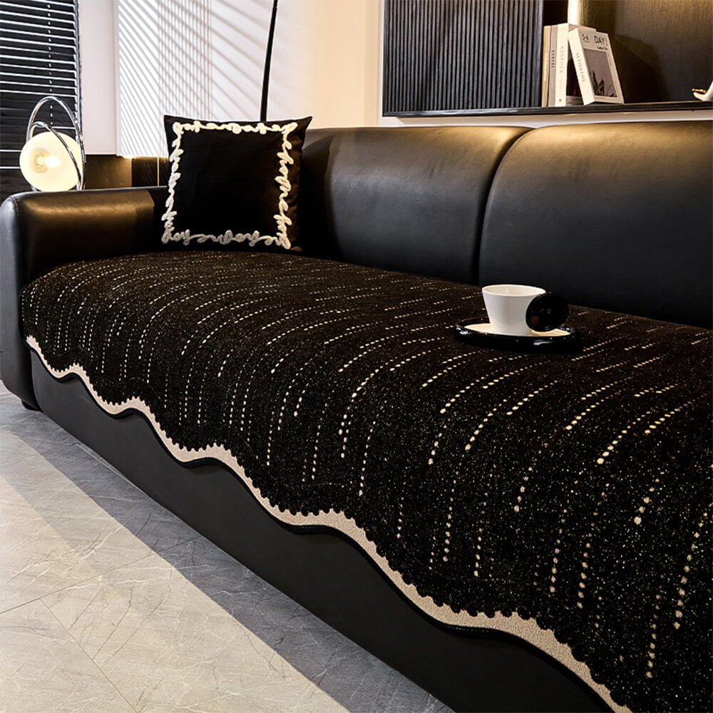 A corner view of a couch showing the elegant wavy chenille protector cover and its secure fit.