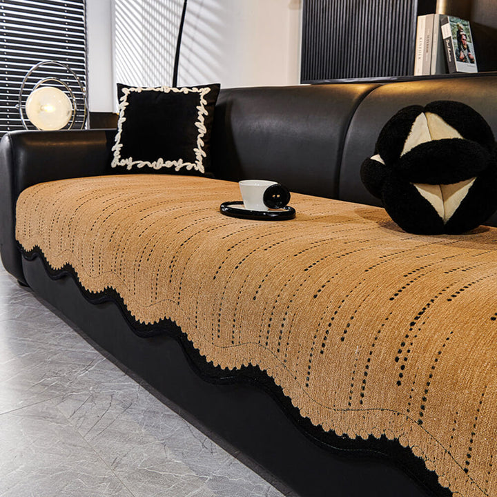 Overhead view of a living room sofa with a cream wavy chenille protector cover, non-slip backing.