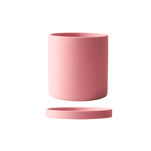 Glazed ceramic planter with saucer for healthy indoor plant growth.