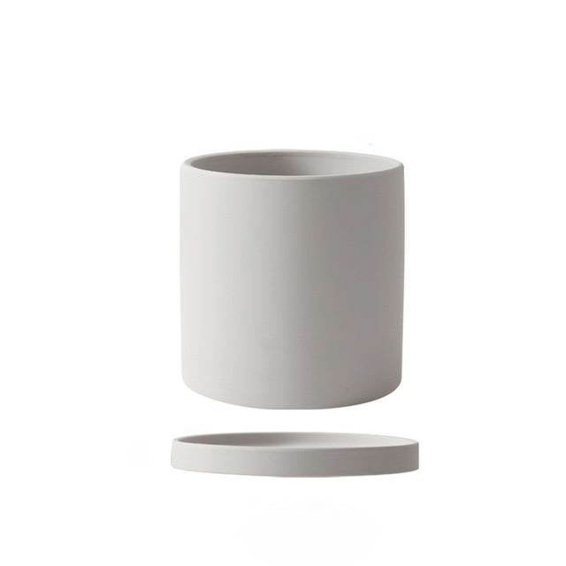 Artistic ceramic flowerpot with saucer, complements modern interior designs.