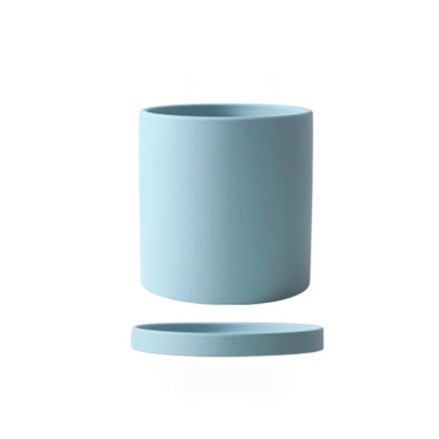 Sleek black ceramic planter with saucer for modern minimalist home decor.
